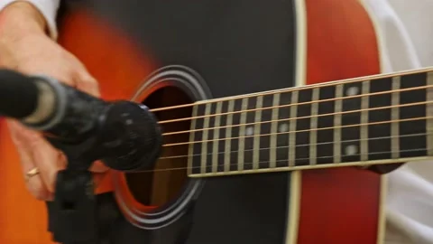 Close-up of a man's hand playing an acoustic guitar during an acoustic concert. Stock Footage 228284408