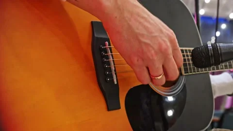 Close-up of a man's hand playing an acoustic guitar during an acoustic concert. Stock Footage 228284467