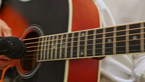 Close-up of a man's hand playing an acoustic guitar during an acoustic concert. Stock Footage 238644985