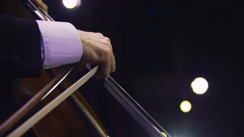 Close-up of man's hand playing contrabass at the concert. Orchestra. 스톡 동영상 303407590