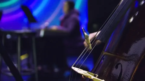 Close-up of man's hand playing contrabass with a bow at the concert. Orchestra. Stock-Footage 303408410