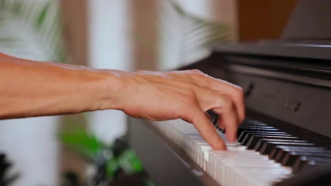 Close-up: man's hand playing gamma on the piano keyboard at home, daytime Stock Footage 158181997