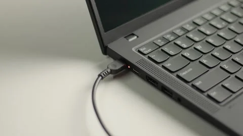 Close up of a man's hand plugging and unplugging a power charger cable Stock Footage 344144224