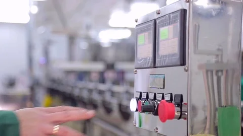 A close-up man's hand presses a button to launch a production line. Stock Footage 82387201