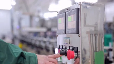 A close-up man's hand presses a button to launch a production line. Stock Footage 82387244