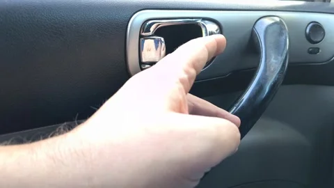Close-up of a man's hand pulling a chrome interior car door handle to open it Vídeo Stock 346603795