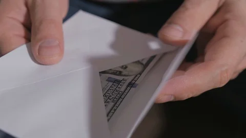 Close-up of a man's hand, pulling out of a paper envelope a lot of hundred Stock Footage 120529502