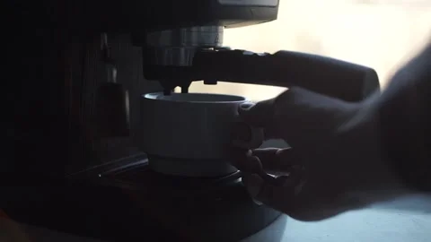 Close-up of man's hand puts up white cup and makes coffee in coffee maker. Stock Footage 201291725