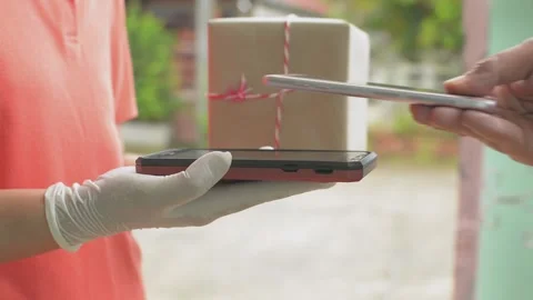 Close up of man's hand receive a parcel cardboard box from a delivery woman. Stock Footage 154672045
