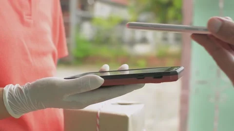Close up of man's hand receive a parcel cardboard box from a delivery woman. Stock Footage 154672051