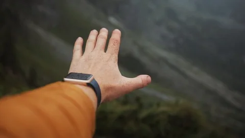 Close up of a man's hand rises in the mountains on the background of the lake Stock Footage 94533938