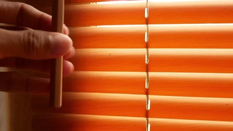 Close-up of a man's hand rolling roller blinds on a window with a curtain roller Stock-Footage 255003330
