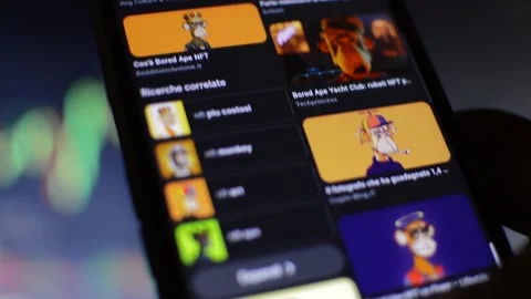 Close-up man's hand scroll NFT art. bored ape non fungible token 스톡 동영상 196925604