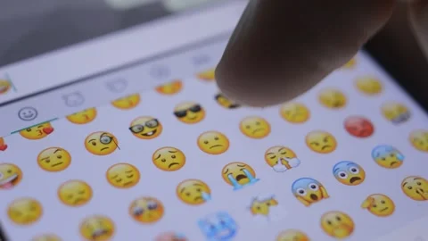 Close-up man's hand scrolling yellow cute emoticon on the phone keyboard. Stock-Footage 220270481