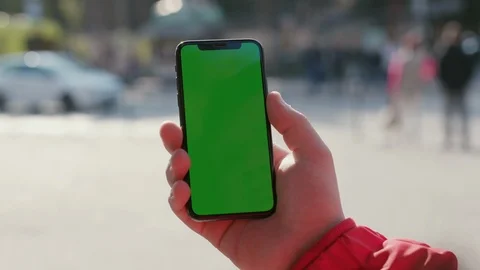 Close-up of man's hand showing vertical greenscreen of modern smartphone mock-up Stock Footage 117428489