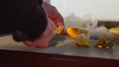 Close-up of a man's hand slicing a lemon 스톡 동영상 188777287