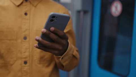 Close-up of a man's hand with a smartphone on the background of a subway car Stock Footage 279726118