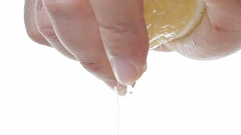 Close up Man's hand squeezing lemon juice on white background. Healthy vegetable Stock Footage 145139756