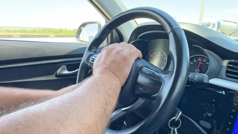 Close up man's hand on steering wheel, driving on highway, automotive, driving Stock Footage 287456359