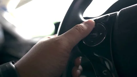 Close up from a man's hand on a steering wheel in a sunny day, driving a car. Stock-Footage 336266167