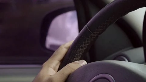 Close up from a man's hand on a steering wheel in a sunny day, driving a car. Stock-Footage 336266214