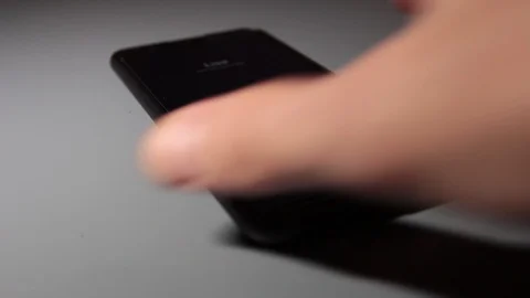 Close up, a man's hand takes a ringing cell phone Stock Footage 120567541