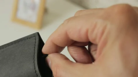 Close-up of a man's hand taking glasses out of a soft leather case Stock Footage 165587734