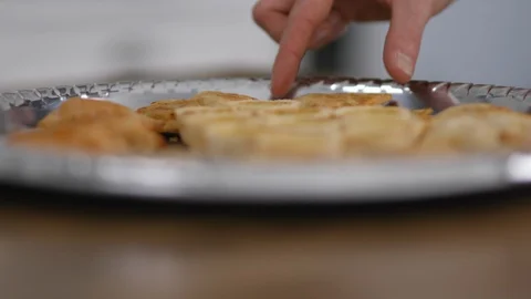 Close up of man's hand taking hors d'oeuvre from a platter Vidéo 103634966
