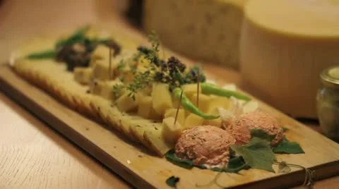 Close up of a man's hand taking served cheese on board Vidéo 27862898