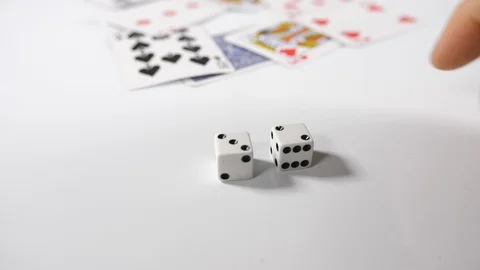 Close up of a mans hand throwing playing cards onto a white surface background Stock Footage 89186816