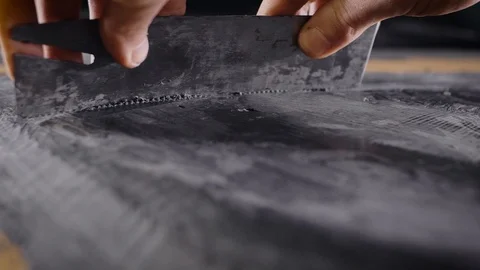 A close-up of a man's hand with a tool. A professional removes the form from the Stock Footage 124479221