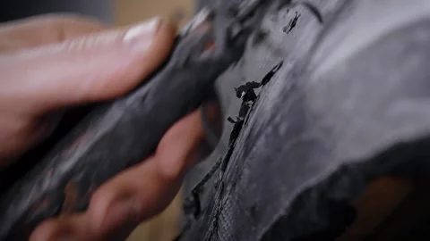 A close-up of a man's hand with a tool. A professional removes the form from the Video stock 144555037