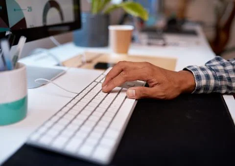 Close up of a man's hand typing on computer keyboard Stock Photos