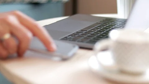 Close-up of man's hand typing on table with smartphone Stock Footage 114871233