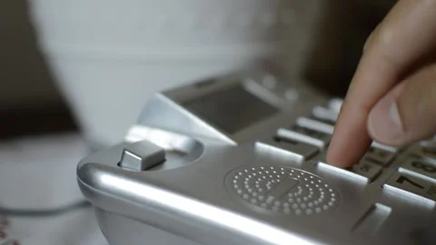 Close-up man's hand usign old telephone and dial number in background 库存影片 200474523
