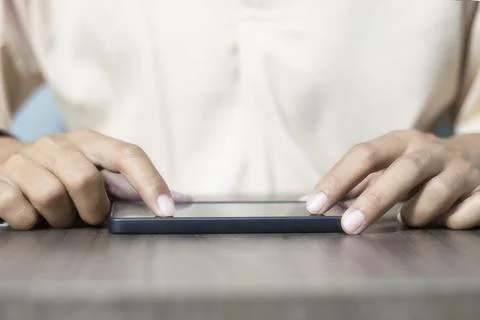Close-up of a man's hand using a cell phone to search for information. On o.. Stock Photos