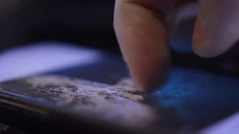 Close-up man's hand using iphone in the dark. scroll iphone screen display. 스톡 동영상 229113775