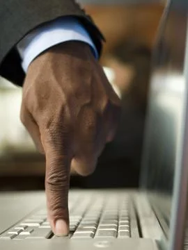 Close-up of a man's hand using a laptop Stock Photos