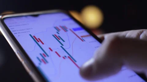 Close-up man's hand using phone for economy business Stock-Footage 201938569