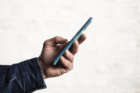 Close up of a man's hand using a smart mobile phone Stock Photos