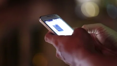 Close-up of a man's hand using smartphone in the city. Video stock 77295032