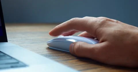 Close up of man's hand using white computer mouse to work at computer. Man Stock Footage 229826268