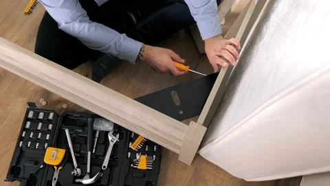 Close-up of a man's hand victoriously throws a screwdriver after an assembling a Stock Footage 220189099
