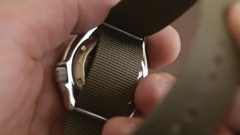 Close-up of a man's hand wearing a nylon khaki strap on a mechanical diver's Video stock 109920173