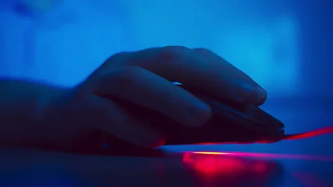Close-up of a man's hand working on a computer through a computer mouse, evening Stock Footage 150712716