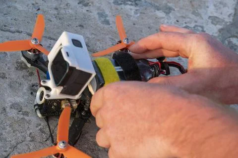 Close up of man's hands assembling FPV drone, preparing quadcopter for flight Stock Photos