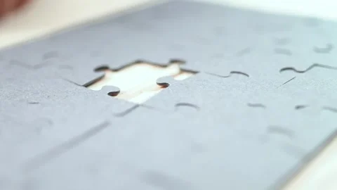 Close-up of Man's Hands Assembling Jigsaw Puzzle on Table. Stock Footage 329929497
