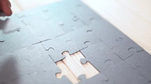 Close-up of Man's Hands Assembling Jigsaw Puzzle on Table. Stock Footage 329929502