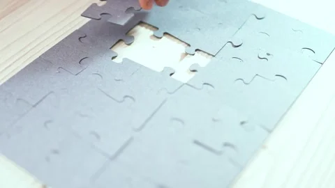 Close-up of Man's Hands Assembling Jigsaw Puzzle on Table. Video stock 329929530