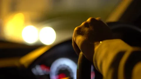 Close-up of man's hands on car steering wheel at night Video stock 133263425